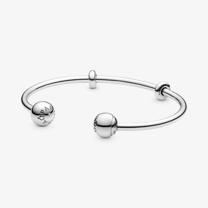 Silver open bangle with silicone stoppers and interchangeable end caps