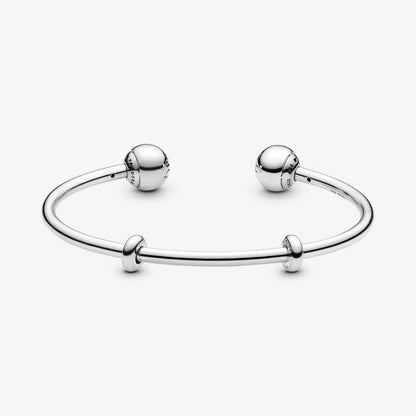 Silver open bangle with silicone stoppers and interchangeable end caps